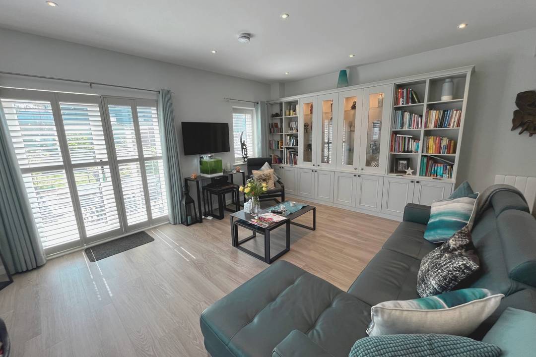 Eco-conscious, design-led detached home in a peaceful village setting with solar tech, Juliet balconies, and private garden.