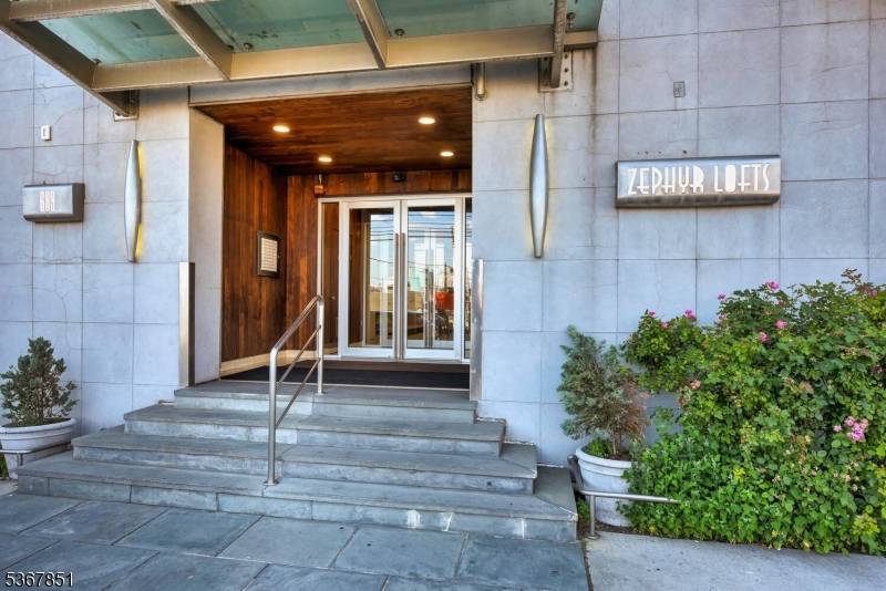 Welcome to The Zephyr Lofts, where luxury meets convenience in this spacious 2 bedroom, 1 bath condo offering stunning, unobstructed NYC skyline views from your private balcony.