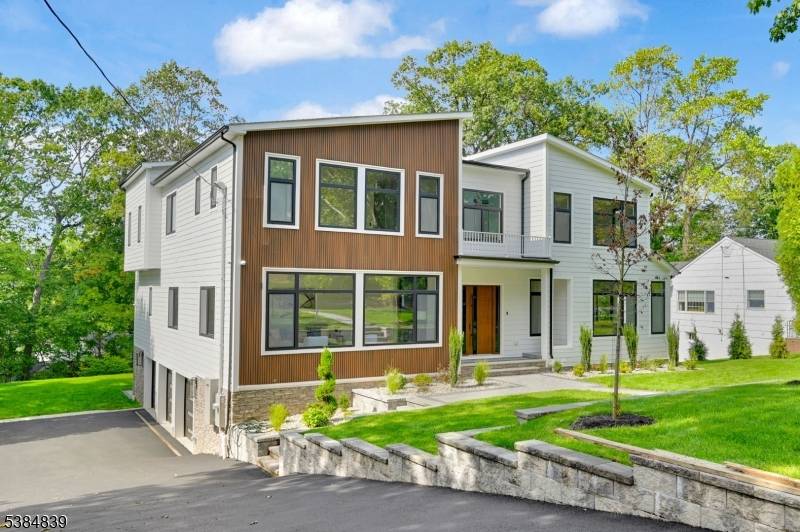 Welcome to 55 Troy Drive, a stunning new construction home in the prestigious Short Hills neighborhood.